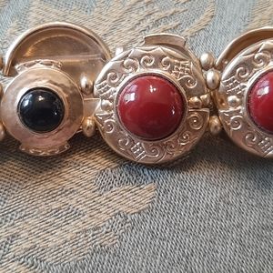 Gold stretch bracelet with dark red and black stones